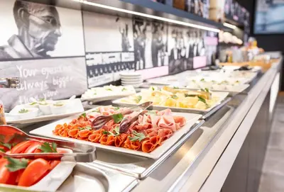 a buffet line with plates of food on display at Hotel Troja in Prague