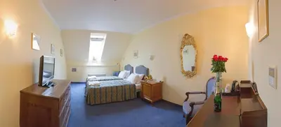 a hotel room with a bed and a television at Hotel Tyl in Prague