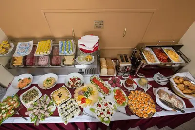 a table filled with lots of different types of food at Hotel Tyl in Prague