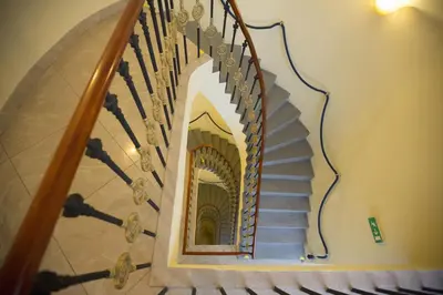 a spiral staircase with a mirror on the side of it at Hotel Tyl in Prague