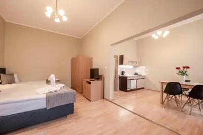 a bedroom with a bed and a table and chairs at Hotel Brixen in Prague