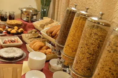 a table topped with lots of different types of food at Hotel Angelis in Prague