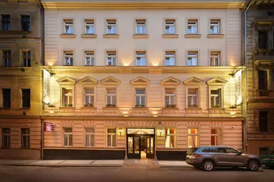 a building with a car parked in front of it at Hotel Angelis in Prague