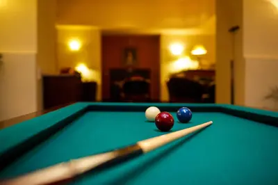 a pool table with three balls on top of it at Hotel St George - Czech Leading Hotels in Prague