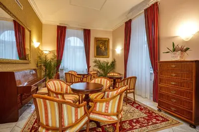 a dining room with chairs and a table and a tablektop at Hotel St George - Czech Leading Hotels in Prague