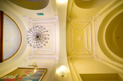 a room with a ceiling with a chandelier at Hotel St George - Czech Leading Hotels in Prague