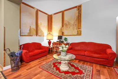a living room with two red couches and a table at Hotel Malá Strana in Prague