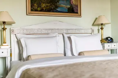 a bedroom with a white bed with two pillows at Golden Well in Prague
