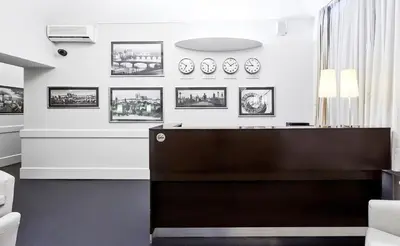 a reception desk in a room with pictures on the wall at La Boutique in Prague
