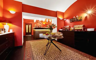 a kitchen with red walls and a table with food on it at La Boutique in Prague