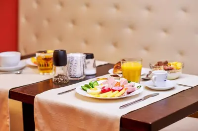 a table with a plate of food and drinks at La Boutique in Prague