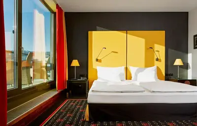 a bedroom with a large bed with a large window at OREA Hotel Angelo Praha in Prague