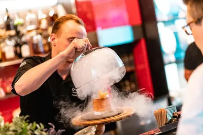 a man is blowing smoke into a food mixer at OREA Hotel Angelo Praha in Prague