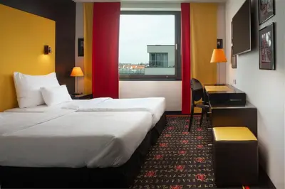 a hotel room with a large bed and a window at OREA Hotel Angelo Praha in Prague