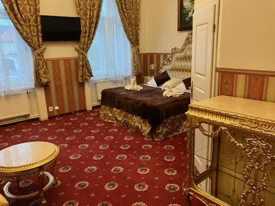 a hotel room with a bed and a table at Hotel Klarinn Prague Castle in Prague
