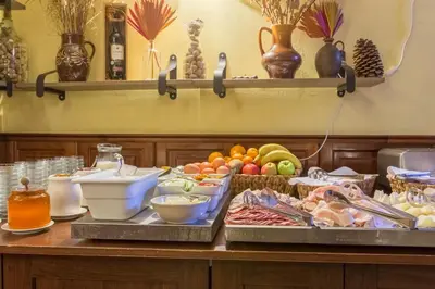 a buffet of food on a table with plates of food at Hotel Klarinn Prague Castle in Prague