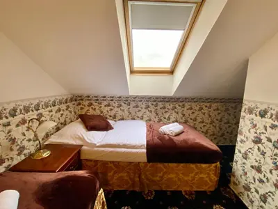 a small room with a bed and a window at Hotel Klarinn Prague Castle in Prague