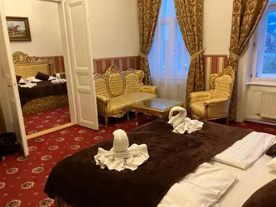 a hotel room with two beds with hats on them at Hotel Klarinn Prague Castle in Prague