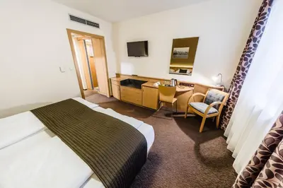 a hotel room with a bed and a desk at Archibald City in Prague