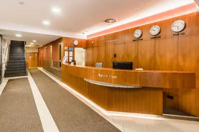 a waiting room with clocks on the wall at Archibald City in Prague