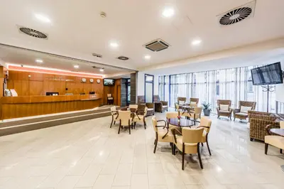 a lobby with tables and chairs and a waiting room at Archibald City in Prague