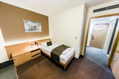 a hotel room with a bed and a door at Archibald City in Prague