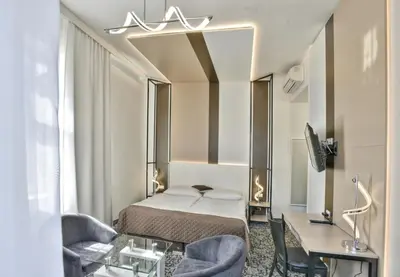 a bedroom with a bed and two chairs and a desk at Máchova in Prague