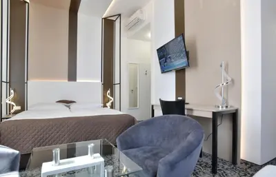 a hotel room with a bed and a chair and a desk at Máchova in Prague