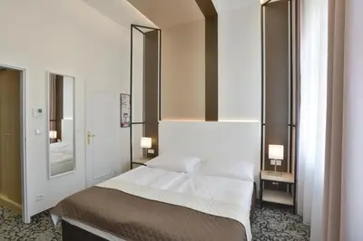 a bedroom with a bed and a mirror at Máchova in Prague