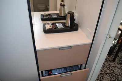 a cupboard with a coffee maker on a shelf at Máchova in Prague