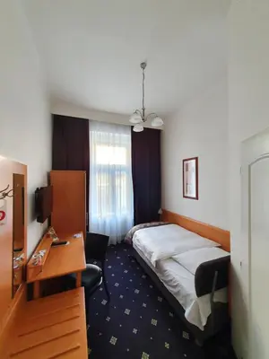 a hotel room with a bed and a desk at Máchova in Prague