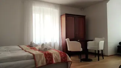 a bedroom with a bed and a desk and a window at Residence Dykova - former Pension Jana, Domov Mládeže in Prague