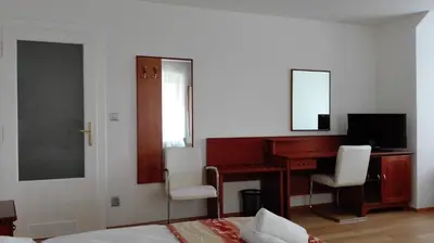 a bedroom with a desk and a computer with two chairs at Residence Dykova - former Pension Jana, Domov Mládeže in Prague