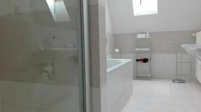 a white bathroom with a shower and a sink at Residence Dykova - former Pension Jana, Domov Mládeže in Prague