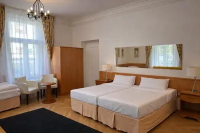 a hotel room with a bed and a mirror at Residence Dykova - former Pension Jana, Domov Mládeže in Prague