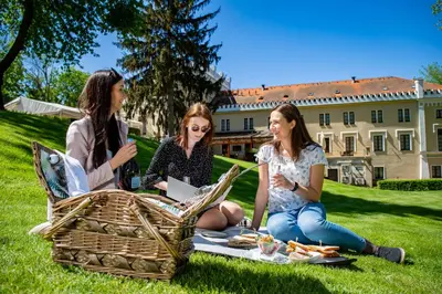 two girls are playing with a frisbee in a park at Chateau St. Havel - Wellness Hotel in Prague