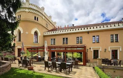 a large white building with a red roof at Chateau St. Havel - Wellness Hotel in Prague