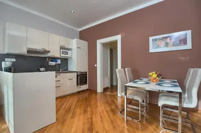 a kitchen and dining room with a table and chairs at Residence Masna in Prague