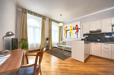 a kitchen and living room with a table and chairs at Residence Masna in Prague