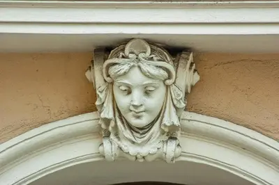 a statue of a face on the side of a building at Residence Masna in Prague
