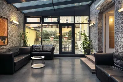 a living room with leather couches and a table at Hotel Galileo in Prague