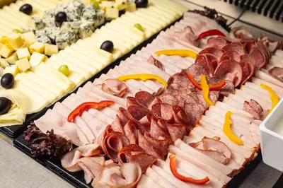 a tray of different types of meats and cheese at Hotel Galileo in Prague
