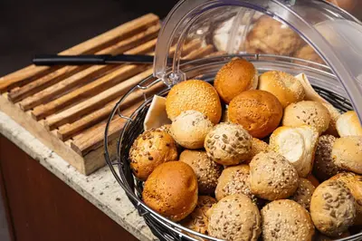 a basket of bagels and other pastries on a counter at Hotel Galileo in Prague
