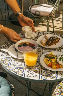 a table with plates of food on top at Monastery Garden Prague in Prague