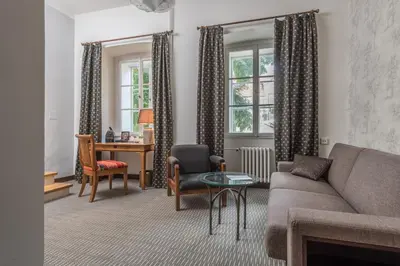 a living room with a couch and a table at Monastery Garden Prague in Prague