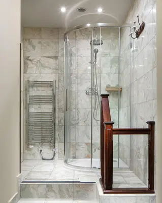 a shower with a glass door in a bathroom at Grand Hotel Praha in Prague