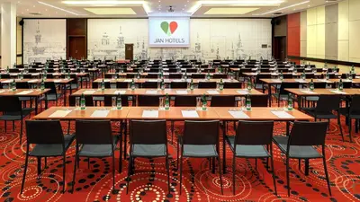 a large room with rows of tables and chairs at Hotel Duo & Wellness in Prague
