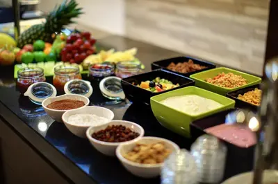 a buffet with bowls of food on a table at Hotel Duo & Wellness in Prague