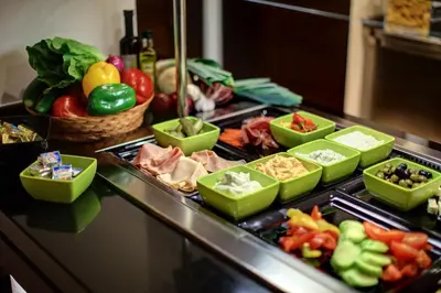 a buffet with different types of food on a table at Hotel Duo & Wellness in Prague