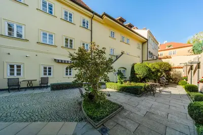 a courtyard with a tree in the middle of a building at Archibald At the Charles Bridge in Prague